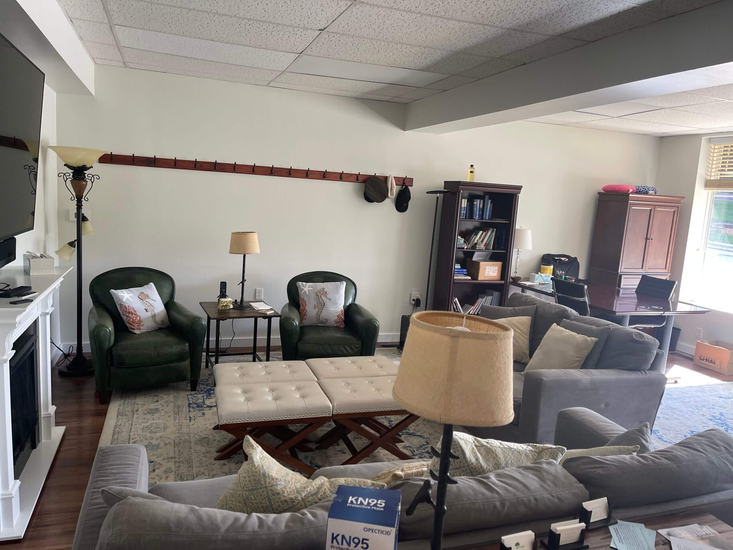 A living room with couches, chairs and tables.