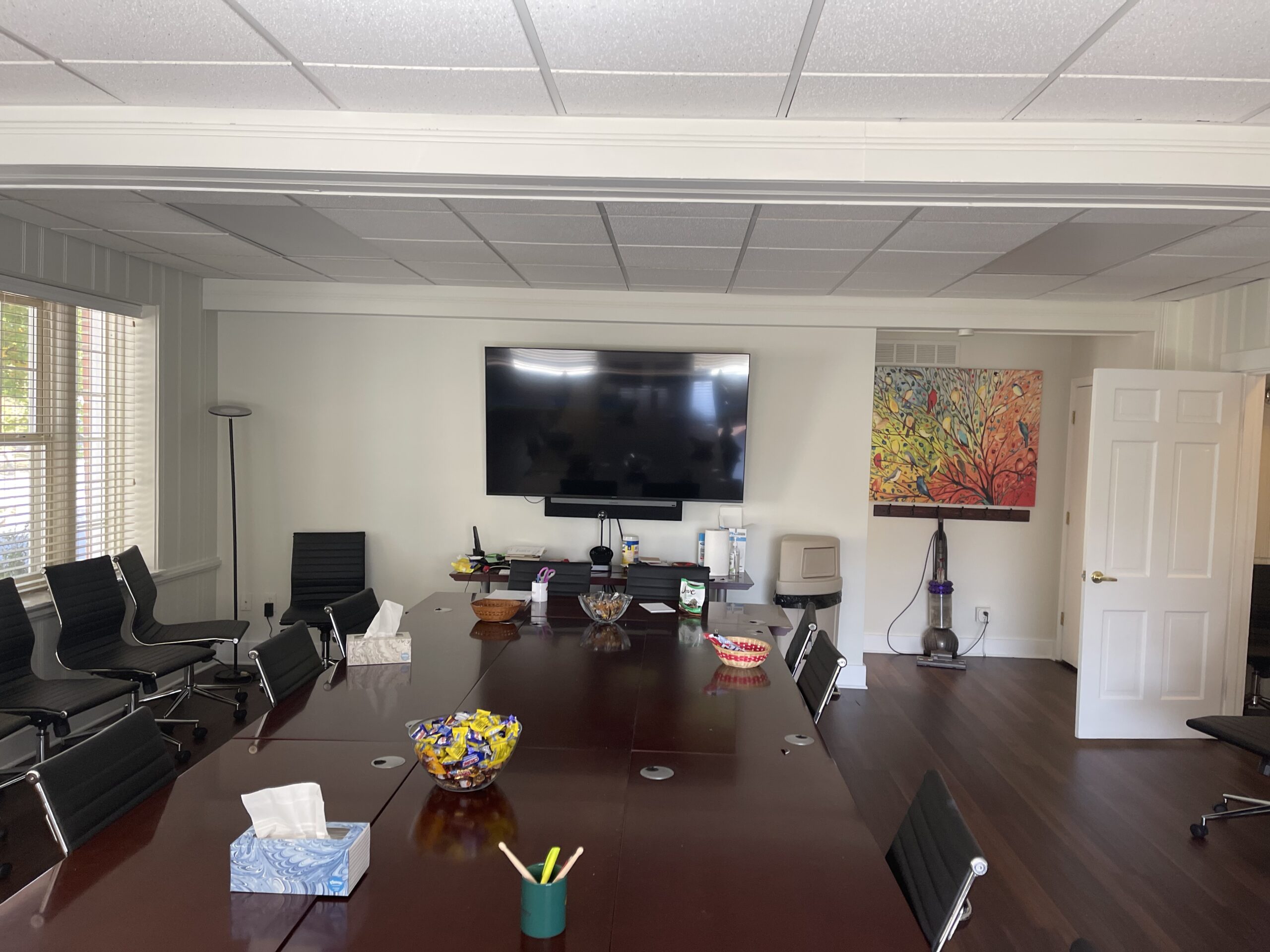 A large conference room with a big screen tv.